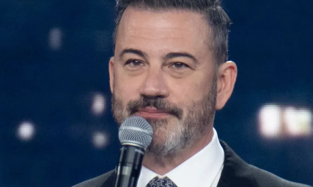 Jimmy Kimmel on stage microphone photo for Jimmy Kimmel Net Worth.