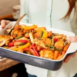 Woman holding tray of food for dinner