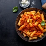Pasta with tomato sauce served on pan