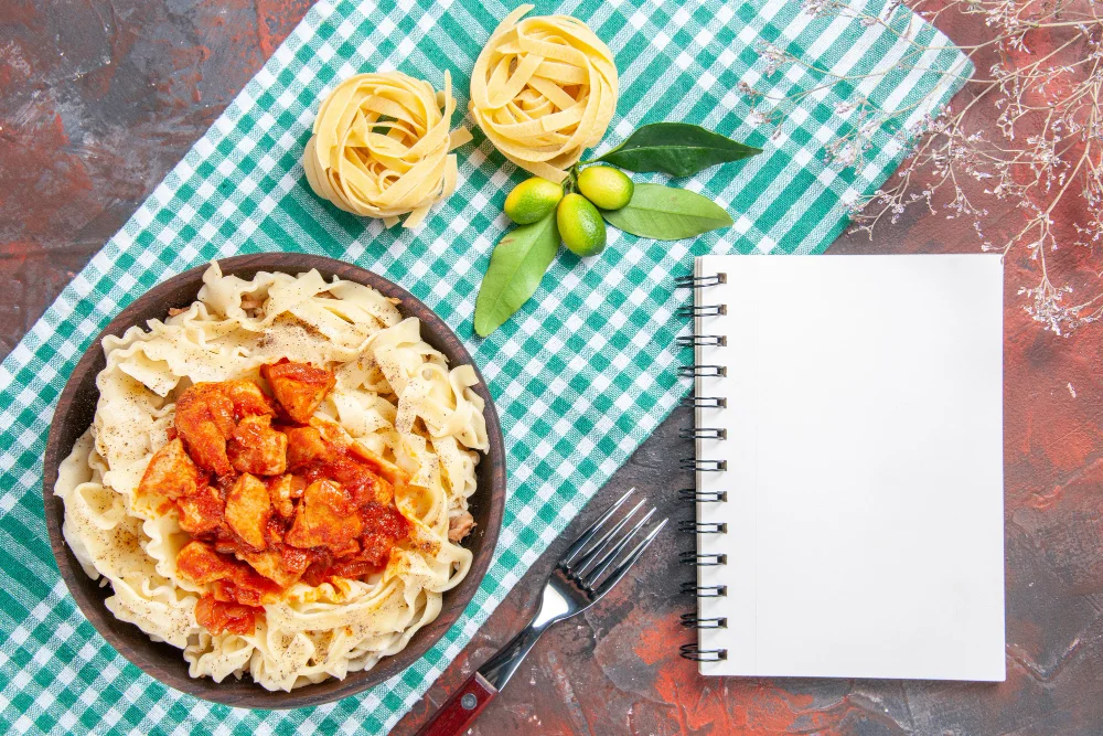Top view tasty cooked dough with chicken and sauce on a dark surface pasta food dish