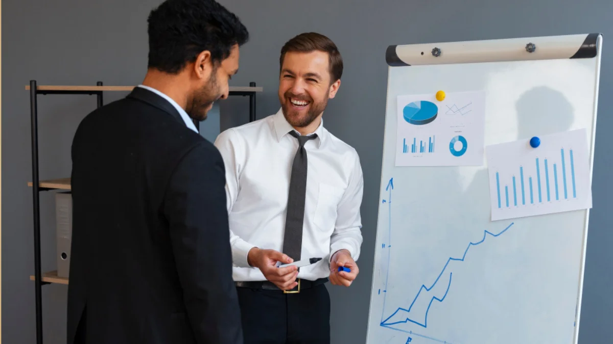 Business owner celebrating growth while SEO consultant shows improved ranking report