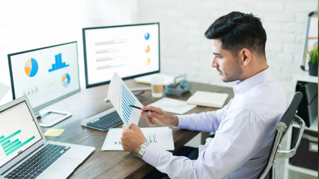 Business professional working on a laptop with SEO reports.