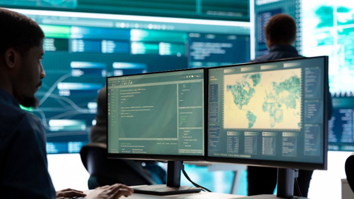 Cybersecurity specialist monitoring website security dashboard on multiple computer screens