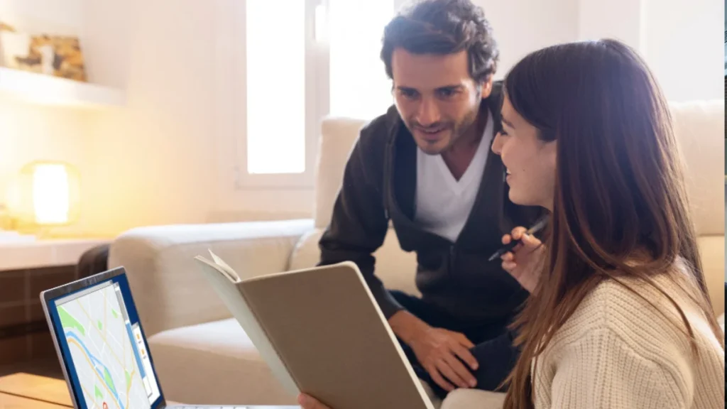 Real estate agent using a laptop with Google Maps on screen