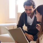 Real estate agent using a laptop with Google Maps on screen