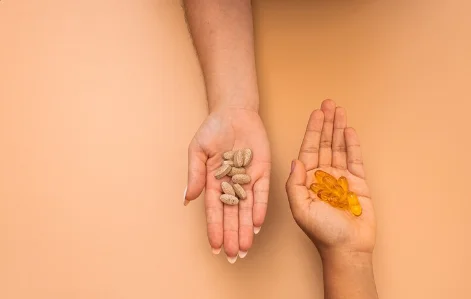 Overhead shot of hands full of drugs on an orange background