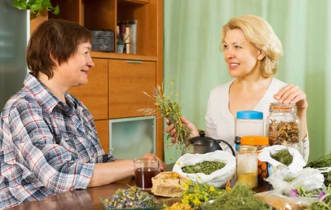 Two mature women with herbs