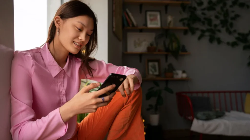 Young woman shopping online using TikTok Shop on her smartphone at home