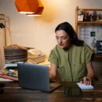 Business owner using laptop to improve local SEO tools strategy in store