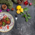 yummy cutlets with onion rings on grey desk dish meat meal cuisine