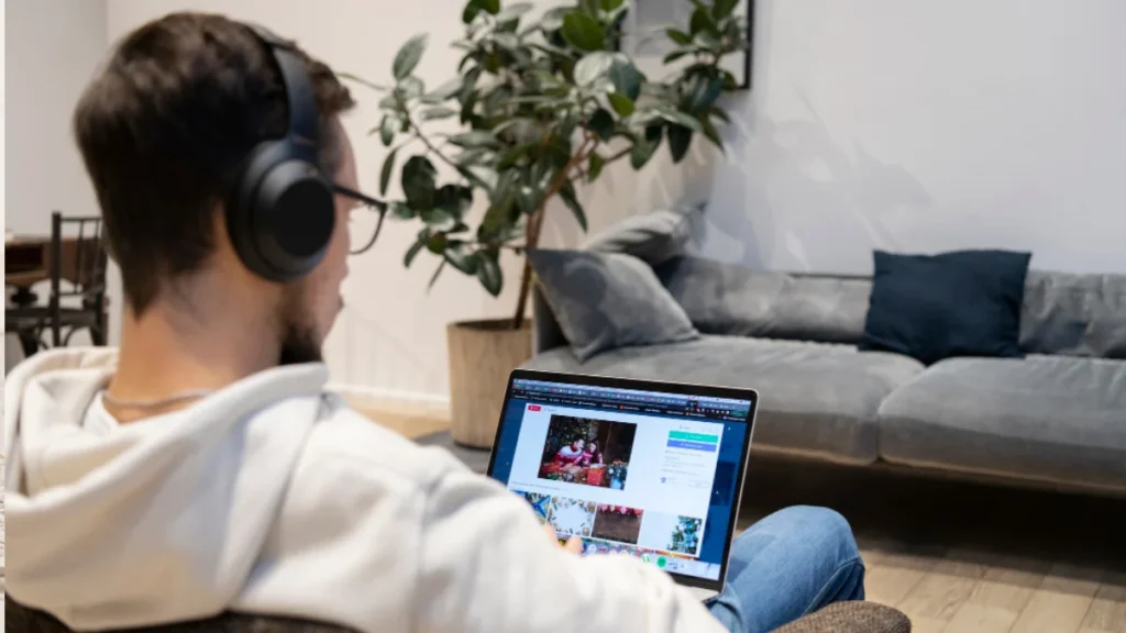 Person managing YouTube automation with laptop and digital video icons around.