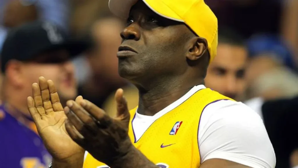 man in a yellow baseball cap and basketball jersey