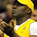 man in a yellow baseball cap and basketball jersey