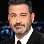 jimmy Kimmel late-night talk show desk photo for Jimmy Kimmel Net Worth.