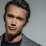 A portrait of American actor, writer, and producer Rob McElhenney against a neutral background, highlighting his career success and estimated Rob McElhenney Net Worth