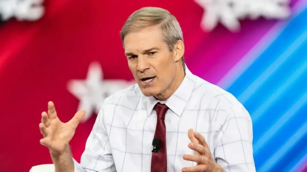 Jim Jordan wealth net worth 2026 highlights his career in politics, shown here with U.S. Representative Jim Jordan gesturing passionately during a speech in a white checkered shirt and red tie.