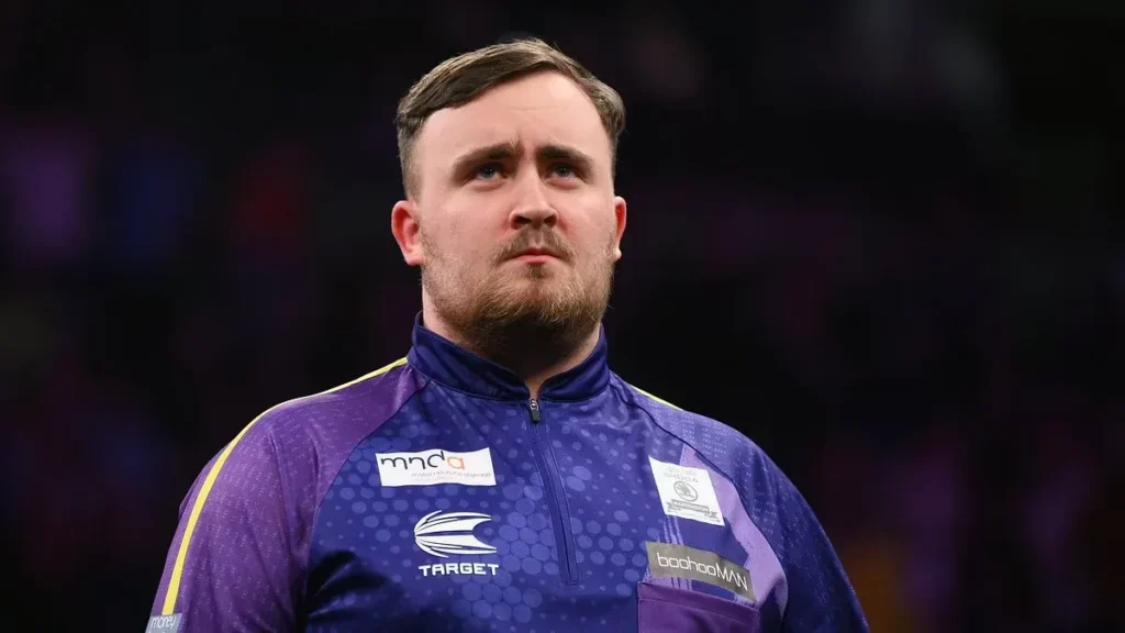 Luke Littler maintains a serious expression during a tournament appearance, illustrating the prominence of the young player and discussions around Luke Littler net worth.